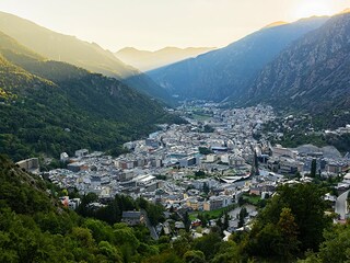 A rail passenger uses a fan to cool down as they sit with their belongings at Euston train station in central London, on July 19, 2022, as services were cancelled due to a trackside fire, and as the country experiences an extreme heat wave.
Image: Niklas Halle"n / AFP