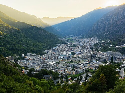 A rail passenger uses a fan to cool down as they sit with their belongings at Euston train station in central London, on July 19, 2022, as services were cancelled due to a trackside fire, and as the country experiences an extreme heat wave.
Image: Niklas Halle"n / AFP