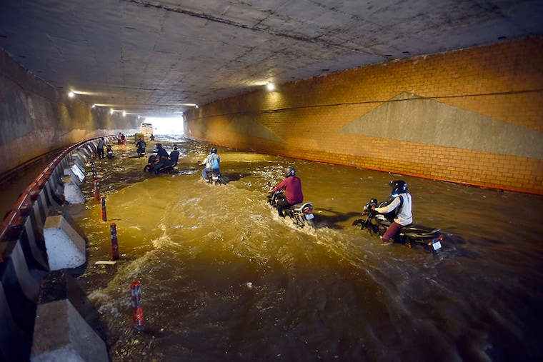 Vehicles wade through a waterlogged underpass near Indira Gandhi International Airport Terminal-1D following heavy rain on July 20, 2022, in New Delhi, India. The heavy downpour caused widespread waterlogging in many parts of Delhi-NCR, affecting traffic movement in parts of the city even as it brought much-needed respite from the sweltering heat.