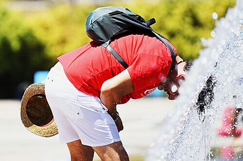 A man refreshes himself at Cinecitta World Park, near Rome on July 23, 2022, during an ongoing heat wave across Europe. Image: Tiziana Fabi / AFP