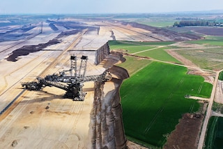 In this aerial view a bucket excavator removes top layers of soil and sand from former farmland during expansion of the Garzweiler II open-cast lignite coal mine on April 22, 2022 near Erkelenz, Germany. Garzweiler supplies the nearby Neurath coal-fired power station, which, according to data from 2020, is Europe"s second biggest emitter of CO2. Image: Sean Gallup/Getty Images