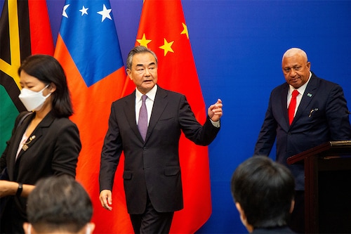 Chinese Foreign Minister Wang Yi (C) leaves after a joint press conference with Fijian Prime Minister Frank Bainimarama (R) in Fiji"s capital city Suva.
Image: Leon Lord / AFP