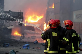 Firefighters try to extinguish a fire that broke out at a container storage facility in Sitakunda, about 40 km (25 miles) from the key port of Chittagong on June 5, 2022. At least 49 people were killed and 170 others injured after a massive fire tore through a container depot in southern Bangladesh, officials said on June 5. (Credits: AFP)
