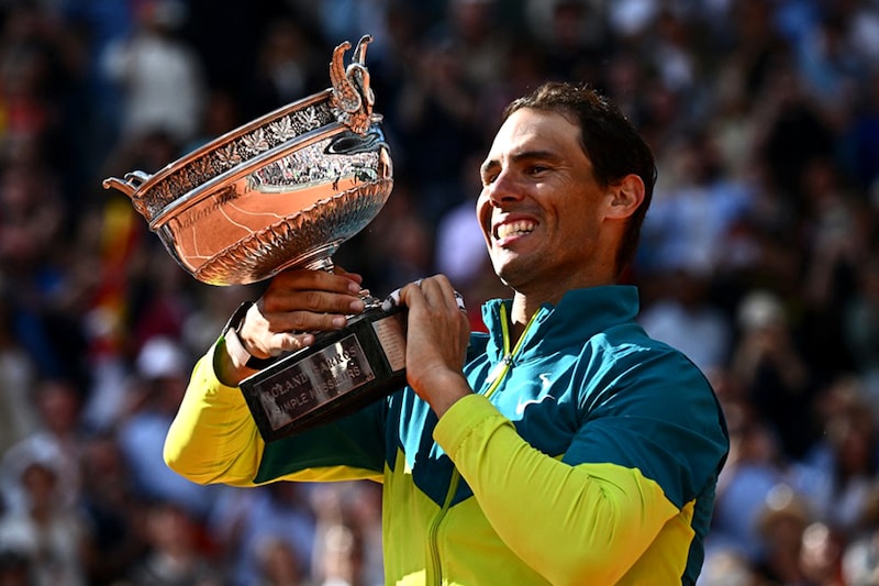 Spain"s Rafael Nadal celebrates with The Musketeers" Cup after victory over Norway"s Casper Ruud during their men"s singles final match on day fifteen of the Roland-Garros Open tennis tournament at the Court Philippe-Chatrier in Paris on June 5, 2022.