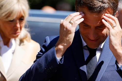 France"s President Emmanuel Macron and his wife French first lady Brigitte Macron arrive to vote in French parliamentary elections at a polling station in Le Touquet, northern France on June 12, 2022. (Image: Ludovic MARIN / POOL / AFP)