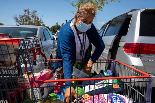 A shopper loads groceries into her car after shopping at Costco in Marina Del Ray, Calif., May 10, 2022. Americans are confronting more expensive food, fuel and housing, and some are grasping for answers about what is causing the price burst, how long it might last and what can be done to resolve it. (Alisha Jucevic/The New York Times)