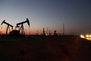 Cars pass near pumpjacks in the Belridge oil field near McKittrick, California. In California, 35,000 oil and gas wells sit idle, many of which are unplugged and could leak methane gas. Scientists estimate that one-third of human-induced global warming is caused by methane. (Photo: MARIO TAMA / Getty Images via AFP)