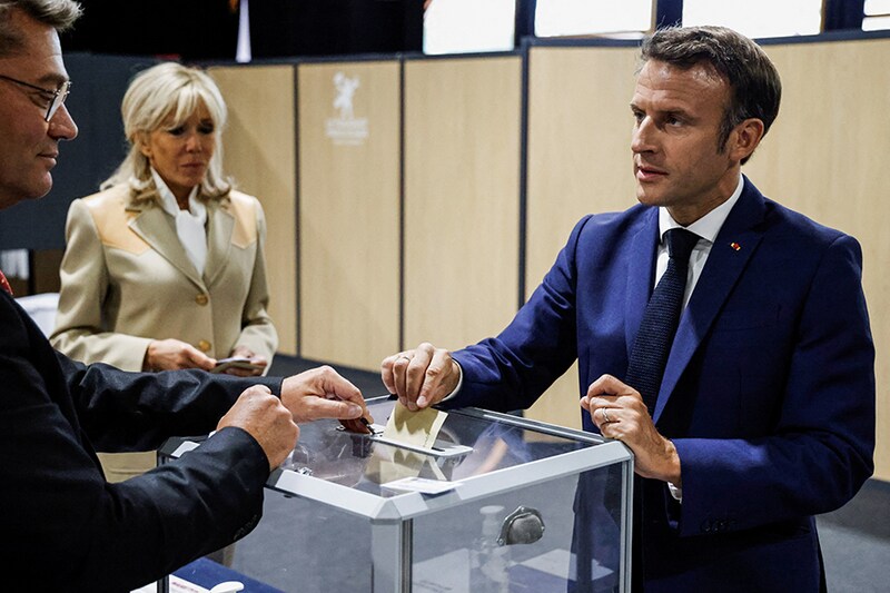 French President Emmanuel Macron casts his vote in the first round of French parliamentary elections, at a polling station in Le Touquet, France on June 12, 2022.