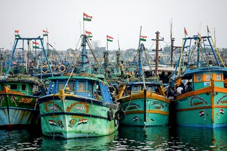Fishermen prepare to set sail at the end of the two-month seasonal fishing ban at Kasimedu fishing harbour in Chennai on June 14, 2022. The WTO proposal to limit subsidies to fishermen of poor and developing nations was strongly objected to by Indian authorities. Nearly nine million fishing families in India depend on Government subsidies.