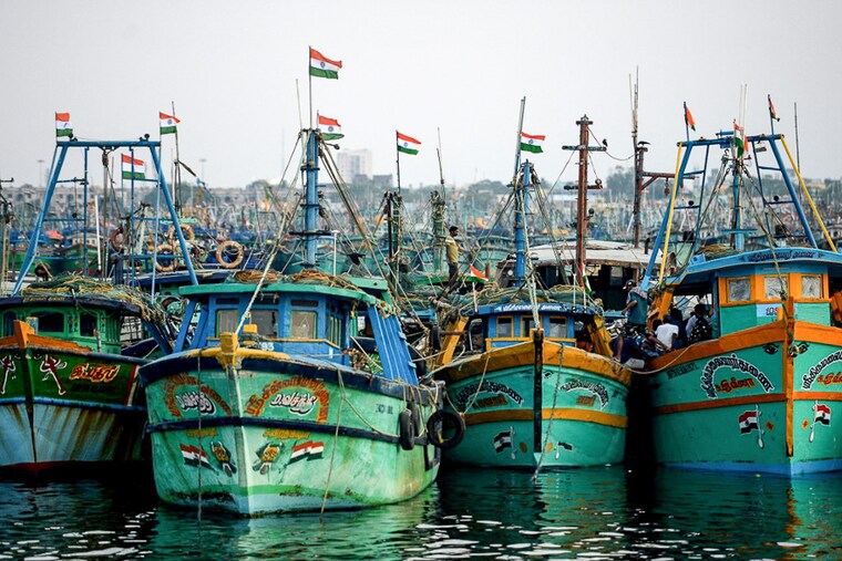 Fishermen prepare to set sail at the end of the two-month seasonal fishing ban at Kasimedu fishing harbour in Chennai on June 14, 2022. The WTO proposal to limit subsidies to fishermen of poor and developing nations was strongly objected to by Indian authorities. Nearly nine million fishing families in India depend on Government subsidies.