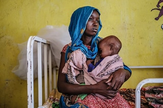 A woman holds a malnourished child at the nutrition unit of the Kelafo Health Center in the town of Kelafo, 120 kilometers from the city of Gode, Ethiopia, on April 7, 2022.&nbspThe worst drought to hit the Horn of Africa for 40 years is pushing 20 million people towards starvation, according to the UN, destroying an age-old way of life and leaving many children suffering from severe malnutrition as it rips families apart. (Image: EDUARDO SOTERAS / AFP)