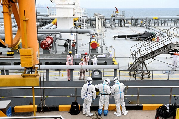 Immigration inspection officers check an oil tanker carrying imported crude oil at Qingdao port in China"s eastern Shandong province on May 9, 2022.
Image: STR / AFP