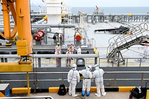 Immigration inspection officers check an oil tanker carrying imported crude oil at Qingdao port in China"s eastern Shandong province on May 9, 2022.
Image: STR / AFP Immigration inspection officers check an oil tanker carrying imported crude oil at Qingdao port in China"s eastern Shandong province on May 9, 2022.
Image: STR / AFP