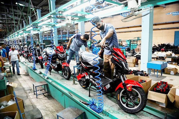 Workers assemble motorcycles at the Angel Villareal Bravo assembly plant, better known as Minerva Cycles, in Santa Clara, in the Cuban province of Villa Clara, on April 26, 2022. Cubans are opting for motorcycles, tricycles and electric cars in the face of the public transportation and fuel shortage crisis. Image: Yamil Lage / AFP