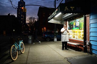 A file photo of a deli worker lighting up a cigarette outside a bodega in Brooklyn, New York on December 10, 2021. Biden"s administration is set to announce a new policy requiring cigarette producers to reduce nicotine to non-addictive levels. Image: Ed Jones / AFP