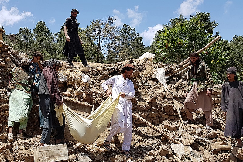 People carry a dead body removed from the debris of a building after a magnitude 6.1 earthquake shook Afghanistan at noon, killed at least 29 people, and injured 62 others in the Spera district of Khost province near Paktika province. According to an estimate, over 1000 people died while around 1500 were insured in Afghanistan on June 22, 2022. The district chief, Sultan Mahmood Ghaznavi, said the quake had destroyed about 500 houses in different parts of the district, adding that they were trying to assist the affected families in Khost.