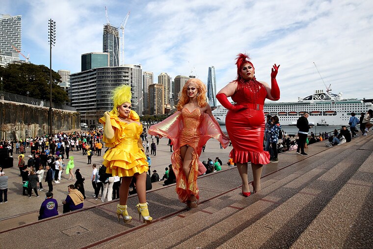 Drag queens Molly Poppins, Sia Tequila, and Pamara pose on the steps of the Sydney Opera House to mark the 44th anniversary of the Sydney Gay and Lesbian Mardis Gras on June 24, 2022, in Sydney, Australia. Australia will host WorldPride 2023.