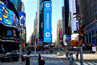 Coinbase’s initial public offering is displayed on the Nasdaq Tower in Times Square in New York, on April 14, 2021. No cryptocurrency investor has been spared the pain of plunging prices however, the fallout from more than $700 billion in losses is far from even. (Gabby Jones/The New York Times).