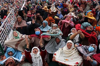 Devotees pray as a priest displays a relic believed to be a hair from the Prophet Mohammad"s beard during Meraj-ul-Alam celebrations at Hazratbal shrine, Srinagar, Kashmir on March 01, 2022.