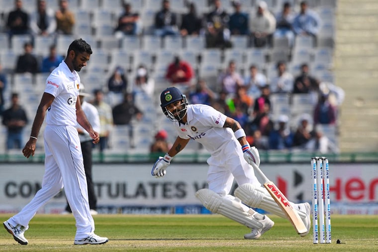 Virat Kohli runs between the wickets during the first day of the first Test cricket match between India and Sri Lanka at the Punjab Cricket Association Stadium in Mohali on March 4, 2022. Virat Kohli is playing his 100th Test match.