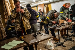 Volunteers are armed at a base where Ukrainian men and women received rapid military training, from intelligence to weapons, in Kyiv on Feb. 28, 2022. If there is one overriding emotion gripping Ukraine right now, it is hate much of the bitterness is directed at Russian President Vladimir Putin, but Ukrainians also chastise ordinary Russians, calling them complicit. (Lynsey Addario/The New York Times)