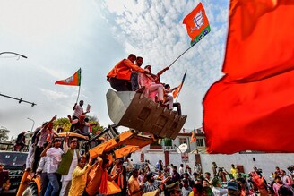 Supporters of India"s Bharatiya Janata Party (BJP) celebrate outside the party office in Lucknow on March 10, 2022, on the day of the counting of votes for the Uttar Pradesh state assembly elections. Looking at the counting trends the BJP is on its way to forming the government in Uttar Pradesh once again.