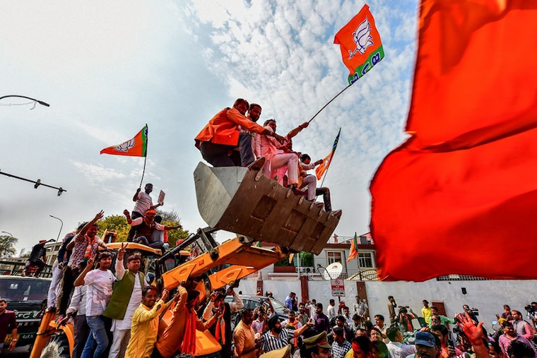 Supporters of India"s Bharatiya Janata Party (BJP) celebrate outside the party office in Lucknow on March 10, 2022, on the day of the counting of votes for the Uttar Pradesh state assembly elections. Looking at the counting trends the BJP is on its way to forming the government in Uttar Pradesh once again.