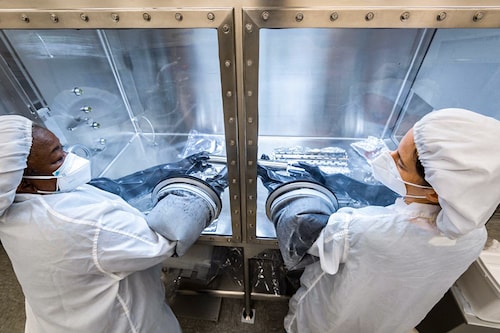 This handout photo released by NASA shows NASA researchers opening an Apollo 17 Moon rock sample at NASAÃ­s Johnson Space Center in Houston on February 15, 2022. - The Apollo missions to the Moon brought back to Earth a total of 2,196 lunar rock samples. But NASA has only just begun to open one of the last, collected 50 years ago. (Credit: Robert MARKOWITZ / NASA / AFP)