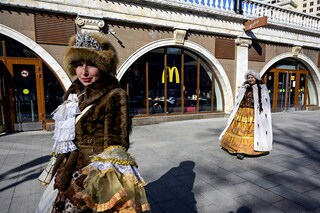 Women walk in front of a McDonald"s restaurant in central Moscow on March 9, 2022. McDonald"s, Coca-Cola and Starbucks on March 8, 2022 bowed to public pressure and suspended their operations in Russia, joining the international corporate chorus of outrage over Moscow"s invasion of Ukraine. Several of these companies, symbols of American cultural influence in the world, have been the subject of boycott calls on social media as investors have also begun to ask questions about their presence. (Credit: AFP)â€‹