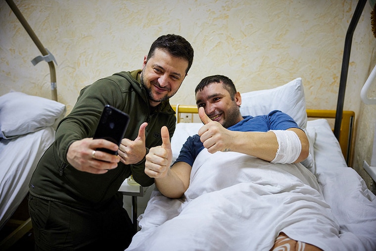 Ukraine’s President Volodymyr Zelenskyy visits an injured Ukrainian serviceman at a military hospital in Kyiv, Ukraine March 13, 2022. Russia"s attack on Ukraine continues.