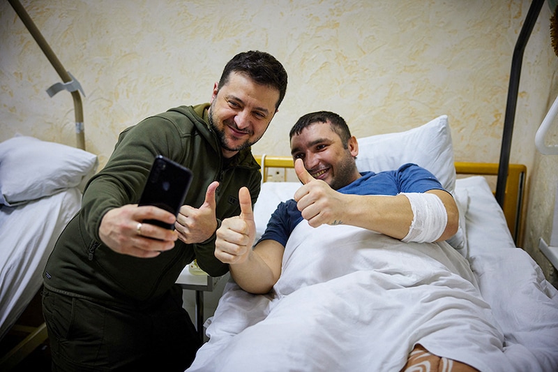 Ukraine’s President Volodymyr Zelenskyy visits an injured Ukrainian serviceman at a military hospital in Kyiv, Ukraine March 13, 2022. Russia"s attack on Ukraine continues.