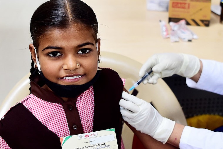 A schoolgirl is administered a dose of Corbevax vaccine during a vaccination drive for 12-14 age group at a vaccination centre in Allahabad on March 16, 2022. Corbevax is developed by the Hyderabad-based Biological E. Ltd in collaboration with the Texas Children’s Hospital Centre for Vaccine Development and Baylor College of Medicine in Houston, Texas. Corbevax uses a recombinant protein platform that is currently not being used by any other vaccine that is being distributed in the country.