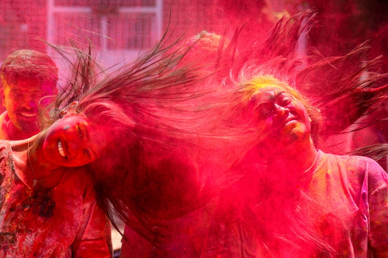 Drenched in colour, revellers celebrate Holi, the Festival of Colours, at Shivaji Park, Dadar on March 18, 2022 in Mumbai, India. The revelry to welcome spring was celebrated with much fanfare across the country, following muted festivities over the past two years due to the coronavirus pandemic.