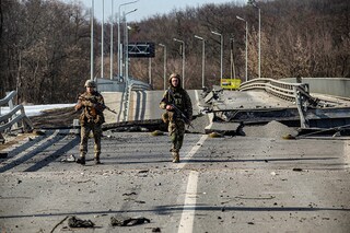 Ukrainian service members walk next to a destroyed bridge between the towns of Trostianets and Okhtyrka amid Russia"s attack on Ukraine continues, in the Sumy region, Ukraine March 19, 2022. (Picture taken March 19, 2022) (Credit: Iryna Rybakova/Press service of the Ukrainian Ground Forces/Handout via REUTERS)