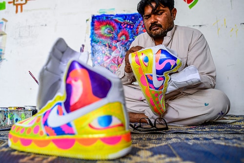 Haider Ali has transposed Pakistan"s renowned "truck art" onto sneakers
Image: Asif Hassan / AFP Haider Ali has transposed Pakistan"s renowned "truck art" onto sneakers
Image: Asif Hassan / AFP