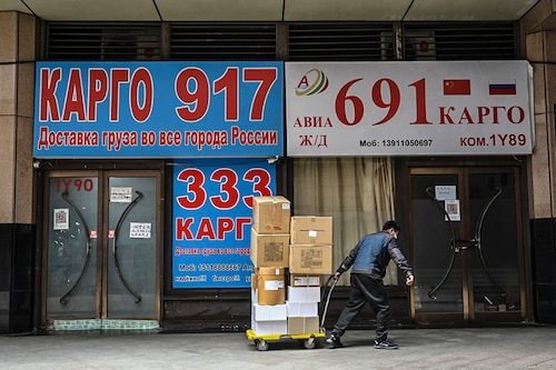 A delivery man hauls packages past stores advertising international logistics transportation to Russia, in Ritan International Trade Center in Beijing on March 22, 2022. Beijing is Moscow"s largest trading partner, with trade volumes last year hitting 147 billion USD, according to Chinese customs data, up more than 30 percent on 2019. (Credit: Jade GAO / AFP) A delivery man hauls packages past stores advertising international logistics transportation to Russia, in Ritan International Trade Center in Beijing on March 22, 2022. Beijing is Moscow"s largest trading partner, with trade volumes last year hitting 147 billion USD, according to Chinese customs data, up more than 30 percent on 2019. (Credit: Jade GAO / AFP)
