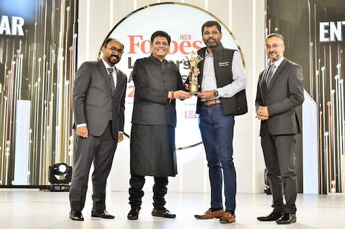 Girish Mathrubootham (third from left) is awarded the Entrepreneur of the Year trophy by Piyush Goyal, India"s Minister of Commerce and Industry at Forbes India Leadership Awards 2022 in Mumbai, 22 March, 2022. Flanking them are Santosh Menon (left), Chief Content Officer, Network 18 and Avinash Kaul (right), CEO Network 18 (Broadcast) & MD, AETN 18.