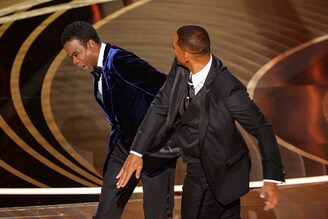 Will Smith (R) hits Chris Rock after the comedian cracked a joke about Smith"s wife Jada Pinkett Smith during the 94th Academy Awards in Hollywood, Los Angeles, California, US on March 27, 2022.