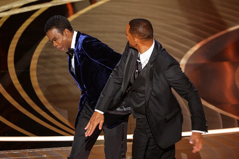 Will Smith (R) hits Chris Rock after the comedian cracked a joke about Smith"s wife Jada Pinkett Smith during the 94th Academy Awards in Hollywood, Los Angeles, California, US on March 27, 2022.