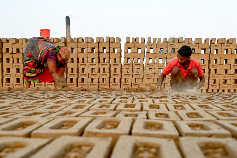 Labourers mould bricks at a brick kiln in Dolike village on the outskirts of Jalandhar, Punjab. Each labourer is paid 800 rupees for every thousand bricks they make, and each of the roughly 1,600 active kilns around Punjab state make about five million bricks each season. Today, the 1st May, is International Workers Day, also known as Labour Day.