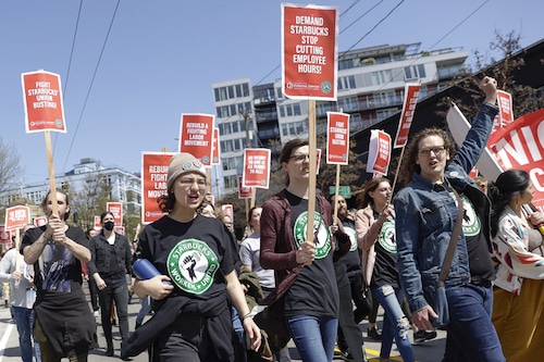 People march in the middle of East Pine Street during the "Fight Starbucks" Union Busting" rally and march in Seattle, Washington on April 23, 2022. (Credits:&nbspJason Redmond / AFP)