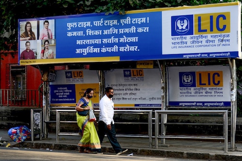People walk past a bus shelter showing advertisement of country"s largest insurer public, Life Insurance Corporation of India (LIC) in Mumbai
Image: Sujit Jaiswal / AFP