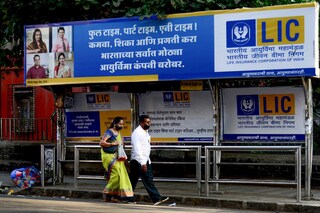 People walk past a bus shelter showing advertisement of country"s largest insurer public, Life Insurance Corporation of India (LIC) in Mumbai
Image: Sujit Jaiswal / AFP