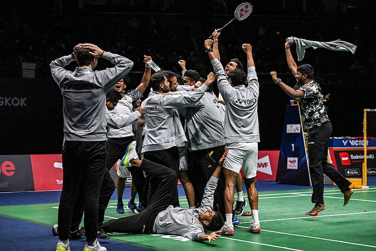 Members of the Indian men"s badminton team celebrate after defeating Indonesia in the men"s finals of the Thomas and Uber Cup badminton tournament in Bangkok on May 15, 2022.