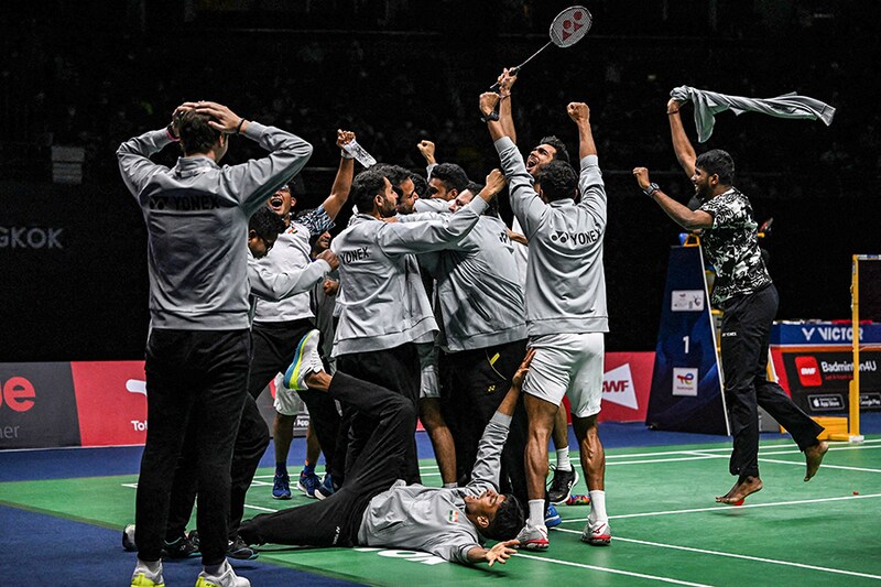 Members of the Indian men"s badminton team celebrate after defeating Indonesia in the men"s finals of the Thomas and Uber Cup badminton tournament in Bangkok on May 15, 2022.