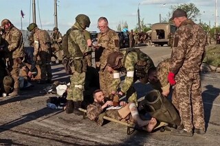 This screen grab obtained from a handout video released by the Russian Defence Ministry on May 17, 2022, shows Ukrainian service members as they are searched by pro-Russian military personnel after leaving the besieged Azovstal steel plant in Ukraine"s port city of Mariupol.â€‹ (Credits: Handout / Russian Defence Ministry / AFP)