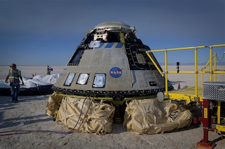 In this handout image courtesy of NASA, Boeing and NASA teams work around Boeing’s CST-100 Starliner spacecraft after it landed at White Sands Missile Range’s Space Harbor, May 25, 2022, in New Mexico. Boeing"s Starliner capsule returned to Earth Wednesday in the final step of a key uncrewed test flight to prove itself worthy of providing rides for NASA astronauts to the International Space Station. (Credits: Bill INGALLS / NASA / AFPâ€‹)