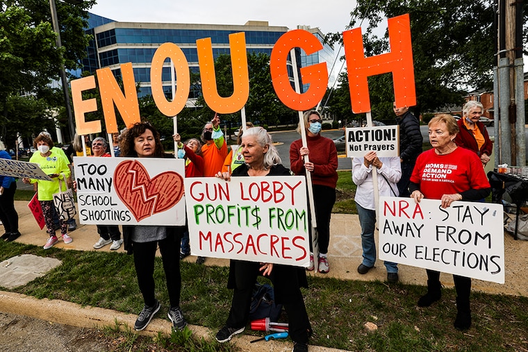 Gun-control advocates protest outside of the National Rifle Association (NRA) headquarters following the recent mass shooting at Robb Elementary School on May 25, 2022, in Fairfax, Virginia. The group is calling for gun law reforms after an 18-year-old gunman killed 19 children and two teachers in Uvalde, Texas.
