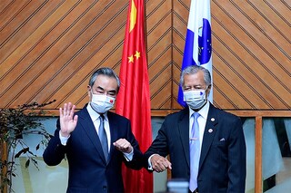 This handout photo taken and released by the Pacific Islands Forum on May 29, 2022 shows Secretary-General of the Pacific Islands Forum Henry Puna (R) and Chinese Foreign Minister Wang Yi (L) posing for photographs during their meeting in Fiji"s capital city of Suva. (Credits: Handout / Pacific Islands Forum / AFP)