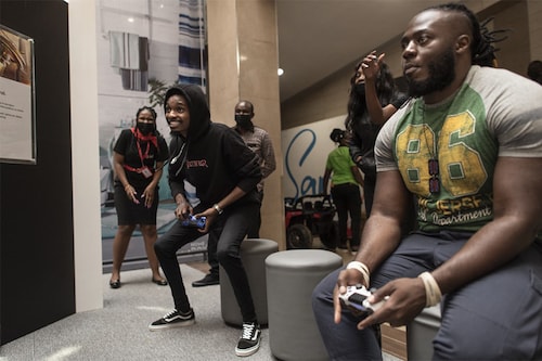 A contestant (L) reacts during a gaming session against Brian Diang"a (R), 28, a gamer popularly known by his online avatar, Beast, at a demo during an exhibition of gaming electronics in Nairobi on October 22, 2021 Image: Tony KARUMBA / AFP